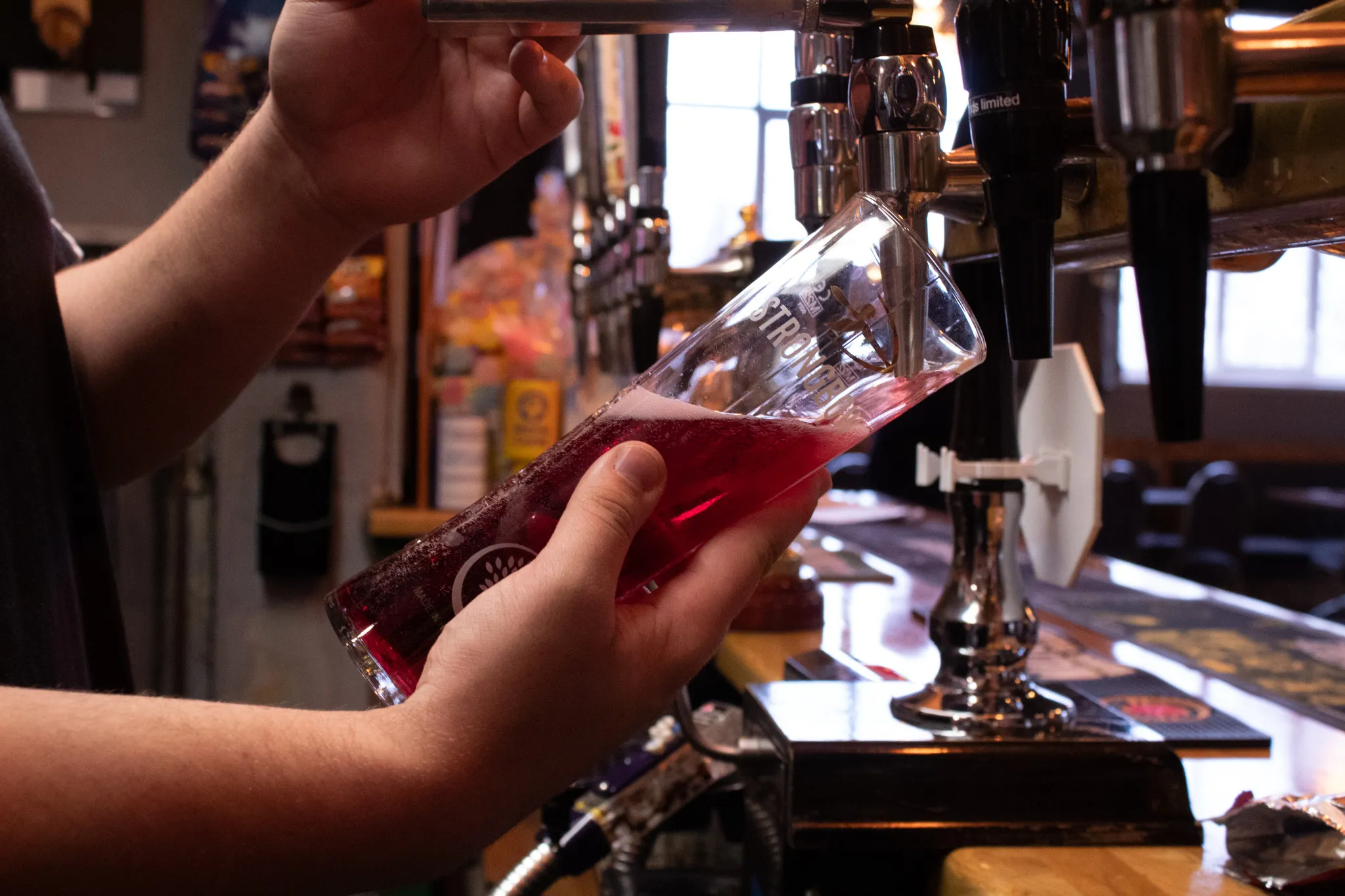 A drink being poured at The Crossings Club bar